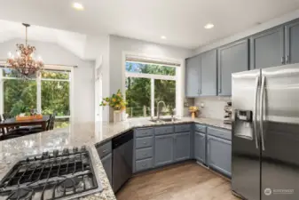 The has been updated with soft grey cabinets, classic subway tile and granite counters.
