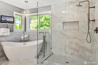 Custom glass shower and free standing tub combined with high end fixtures makes this bathroom feel like a spa.