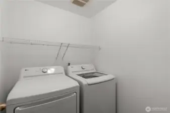 Another view of the laundry room, with extra storage above the washer & dryer to keep things organized and tidy.