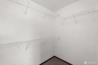 Spacious walk-in closet in the primary suite offers ample storage and organization.