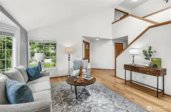 Another view of the living room towards the front entry - door to garage is to the right of the front door, laundry/half bath just past that door.