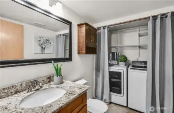 Laundry room/half bath is on the main floor near the door to the garage and near the family room at the bottom of the stairs to the bedrooms.