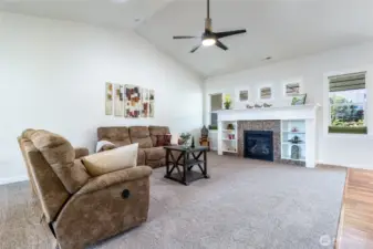 Spacious living room with gas fireplace and vaulted ceilings.