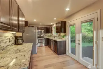 Upgraded kitchen with undermount lighting and beautiful granite counter tops.