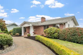 Welcome Home! This home features brick exterior with a columned front porch and large picture windows. Professionally landscaped front yard features manicured hedges, mature shrubs, and a curved brick driveway.