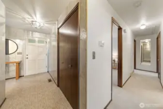 The hallway includes a convenient guest closet near the front entry. Three bedrooms are nestled together on the main level, with two additional bedrooms located on the lower-level for added flexibility.