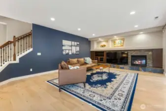 Expansive great room showcases windows that flood the space with natural light and frame peaceful backyard views. Open concept design flows seamlessly to the covered deck through sliding doors—perfect for effortless indoor/outdoor living and entertaining.