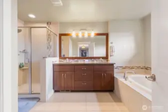 Spa-inspired 5-piece primary bath includes dual sinks, soaking tub, and separate shower. Spacious layout offers both comfort and function, with added touches like TV power and connections for next-level relaxation.