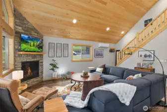 A custom log railing leads from the great room to a generously sized bunk room.