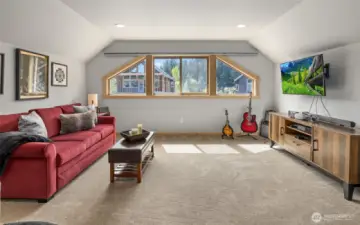 A spacious bunk room upstairs provides ample sleeping accommodations while also functioning as a versatile rec room for fun and relaxation.