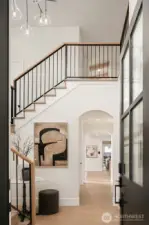 Grand entryway featuring over 18 foot ceilings and an open, airy layout that sets the tone for the home’s elevated design.