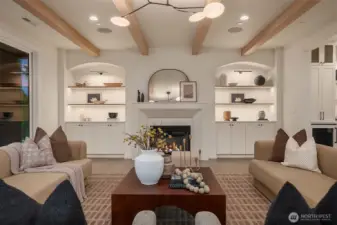 Great room with exposed beams, fireplace, and arched built-ins offering seamless flow to the kitchen and dining areas.