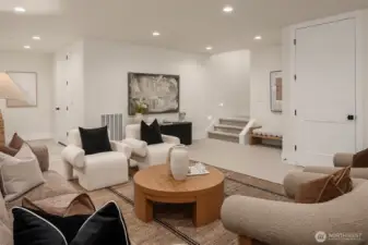 The lower-level bonus lounge has an open layout, ideal for entertaining, relaxing, or multi-use living.