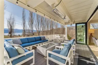 Sunny outdoor living area off the main level living room w/ NanaWall folding window walls, overhead infrared heaters & stunning west-facing uplake views of Lake Chelan.