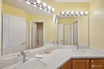 Full bathroom with amazing lighting sits between both upstairs bedrooms opposite of the primary.
