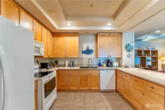 The kitchen features wood cabinetry and granite counter tops. Lots of storage for pots and pans.