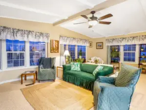 The current seating area in the living room is perfect for gathering around the fireplace.  The ceiling fan helps circulate the warm or cooled air.