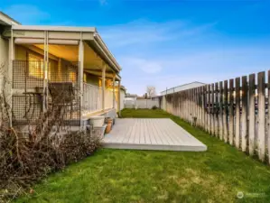 Covered back porch plus extra patio space in the back yard.