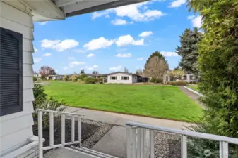 View of large grass area from front porch