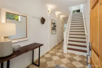Entryway with stairs up to main living floor.  One bedroom, laundry, and garage access here.