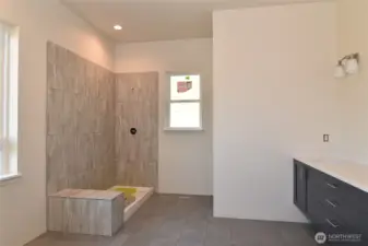 Primary bathroom. The shower will have glass doors, and a soaking tub will be installed beneath the window.