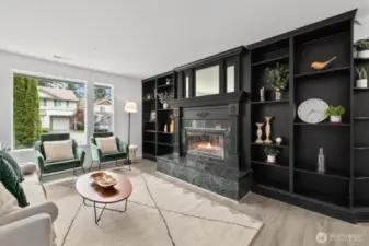 Wood burning fireplace with gorgeous black mantel and built-in shelving