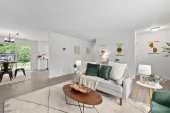 Living room, dining area and kitchen all flow seamlessly with new LVP flooring throughout the home