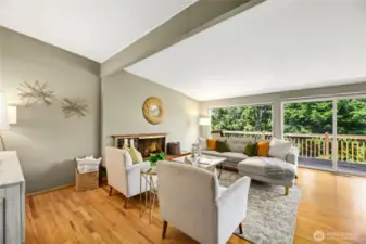 Living Room opens to outdoor deck above swimming pool and greenbelt.