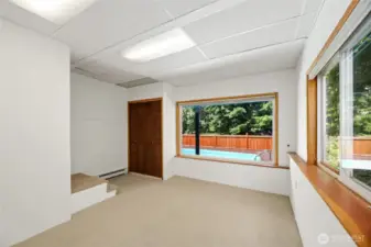 Downstairs bedroom or home office that overlooks the pool and greenbelt.
