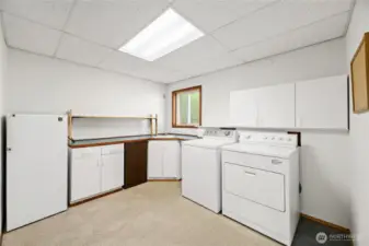 Spacious laundry room with small refrigerator for pool entertainment. North facing window.