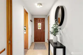 Interior shot of entry door with kitchen entry to the left and stairs to basement in the foreground. This seller was the original owner of the property (1963).