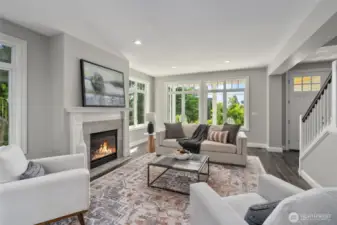 A refined living space bathed in natural light, anchored by a stately fireplace.
