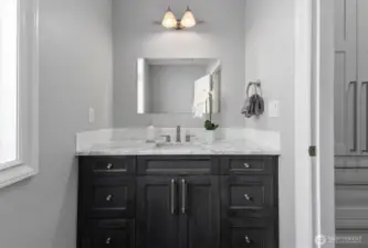 A sophisticated powder bath on the main level with stunning Carrara marble details.