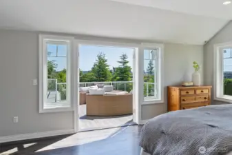 Wake up to breathtaking views in the primary suite that opens to a vast deck.