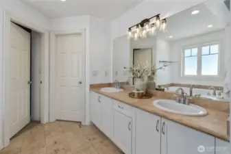 A spa-like primary bathroom and spacious walk-in closet designed for ultimate relaxation and luxury.