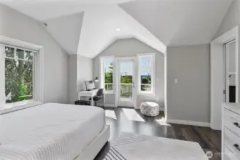 Light-filled en-suite bedroom with vaulted ceilings, private deck access, and a serene work-from-home nook.