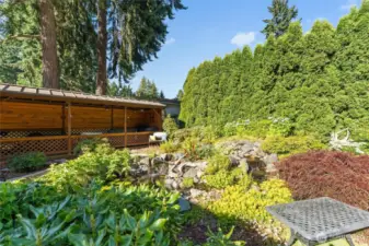 The sound of tranquil waterfall feature including Koi, goldfish, and blown glass yard art.