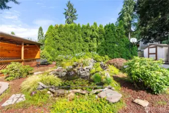 The sound of tranquil waterfall feature including Koi, goldfish, and blown glass yard art.