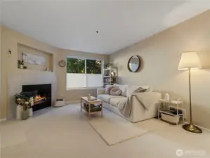 The living room features a cozy wood fireplace with tile surround.