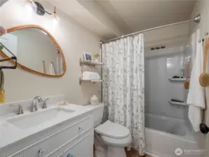 Bathroom has been completely remodeled with new flooring, vanity and shower/tub surround.