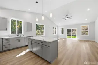 Past the entry to the great room.  Vaulted ceiling, counter tops are Quartz, cabinetry is custom and plywood.
