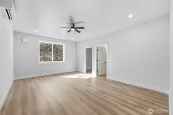 Large primary with walk in closet, double vanity, walk in shower.