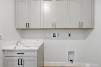 Laundry off garage, custom cabinetry and Quartz counters.