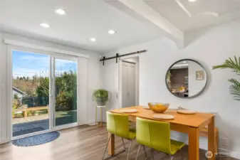 These sliders lead you directly to the pavered patio dining area and the detached studio in large back yard