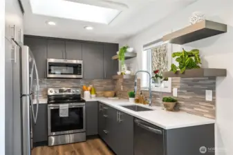 Fantastic kitchen w/quartz counters, stainless appliances and some extra pantry space (not seen in photo)