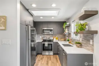 Kitchen has a skylight and window by the sink for great view of the fenced backyard