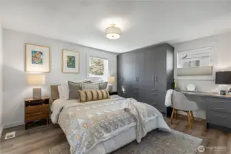 Spacious primary with ensuite bathroom and copious amounts of built-in storage and desk