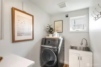 Laundry area off of kitchen, w/combo washer/dryer that seller swears by and utilitiy sink.  This is also the access to the attached garage