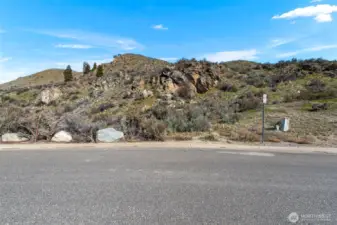 Corners are marked thanks to a recent survey.  Water, sewer and power are in the road.