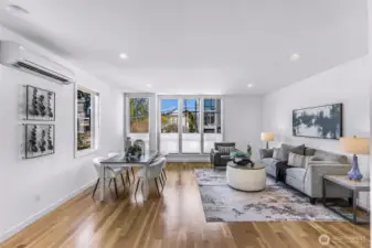 Main level LARGE family room with beautiful gleaming real hardwood floors.